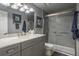 Bathroom featuring vanity with marble countertop, cabinet storage and a glass shower at 30 Turner St # 604, Clearwater, FL 33756