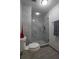 Bathroom featuring a glass shower with unique tile and a modern toilet at 30 Turner St # 604, Clearwater, FL 33756