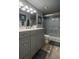 Bathroom featuring vanity with marble countertop, cabinet storage and a glass shower at 30 Turner St # 604, Clearwater, FL 33756