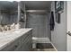 Bathroom featuring vanity with marble countertop, cabinet storage and a glass shower at 30 Turner St # 604, Clearwater, FL 33756