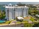 Exterior shot of a white condominium building with surrounding landscaping and bay views at 30 Turner St # 604, Clearwater, FL 33756