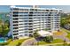 Wide shot of the exterior of a white condominium building with a circular driveway at 30 Turner St # 604, Clearwater, FL 33756