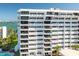 A corner view of a pristine white condo building with private balconies and waterfront views at 30 Turner St # 604, Clearwater, FL 33756