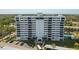 Exterior view of the condo building showcases its multiple balconies, swimming pool, and parking area at 30 Turner St # 604, Clearwater, FL 33756