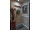 Hallway with door decorated with wreath, striking artwork, and neutral walls create a welcoming ambiance at 30 Turner St # 604, Clearwater, FL 33756