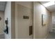 Hallway leading to the women's and men's sauna, with neutral decor and art at 30 Turner St # 604, Clearwater, FL 33756