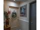 Hallway with door decorated with wreath, striking artwork, and neutral walls create a welcoming ambiance at 30 Turner St # 604, Clearwater, FL 33756