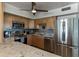 Open concept kitchen featuring stainless steel appliances, light wood cabinets, and marble countertops at 30 Turner St # 604, Clearwater, FL 33756