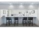 Kitchen view showcasing bar seating, white cabinets, and appliances, blending style and functionality at 30 Turner St # 604, Clearwater, FL 33756