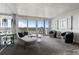 Modern living room with ample seating and a view of the city from the balcony at 30 Turner St # 604, Clearwater, FL 33756