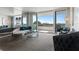 Bright living room with floor to ceiling mirrors and sliding glass doors to balcony with a view at 30 Turner St # 604, Clearwater, FL 33756