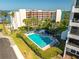 Beautiful community pool with lounge chairs surrounded by manicured bushes and greenery at 30 Turner St # 604, Clearwater, FL 33756