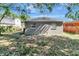 This property features a backyard and an exterior of the house, all under a clear, blue sky at 3003 E 27Th Ave, Tampa, FL 33605