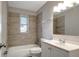 Updated bathroom featuring modern vanity, new fixtures, tiled walls, and a shower-tub combo at 3003 E 27Th Ave, Tampa, FL 33605