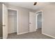 Bright bedroom featuring neutral walls, carpeted flooring, and an open closet with shelves and rod at 3003 E 27Th Ave, Tampa, FL 33605