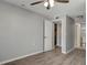 Bedroom with wood-look floors, ceiling fan, and access to a bathroom at 3003 E 27Th Ave, Tampa, FL 33605