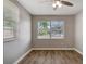Bedroom with wood-look flooring and a bright window overlooking the street at 3003 E 27Th Ave, Tampa, FL 33605