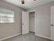 Cozy bedroom with neutral walls, window with blinds, and closet with open door, and ceiling fan at 3003 E 27Th Ave, Tampa, FL 33605