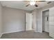 Clean, neutral bedroom with carpeted floors, closet, and ceiling fan for comfort at 3003 E 27Th Ave, Tampa, FL 33605