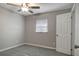 Bedroom with carpet, ceiling fan, a window and a door at 3003 E 27Th Ave, Tampa, FL 33605