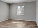 Comfortable bedroom with laminate flooring, a neutral color, and a bright window at 3003 E 27Th Ave, Tampa, FL 33605
