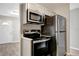 Kitchen with new stainless steel appliances, including a microwave, oven, and refrigerator at 3003 E 27Th Ave, Tampa, FL 33605