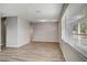 Spacious living room featuring new laminate flooring, fresh paint, and ample natural light at 3003 E 27Th Ave, Tampa, FL 33605