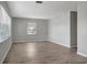 Bright living area with laminate flooring, a neutral color scheme, and a large window at 3003 E 27Th Ave, Tampa, FL 33605