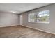 Inviting living room features modern laminate flooring, neutral paint, and a sunlit window at 3003 E 27Th Ave, Tampa, FL 33605