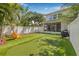 An immaculate backyard with lush artificial turf, putting green, and screened lanai at 307 S Gomez Ave # 1, Tampa, FL 33609