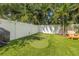 Manicured backyard with a putting green, privacy fence, and tropical foliage at 307 S Gomez Ave # 1, Tampa, FL 33609