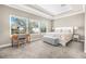 Bright bedroom featuring a tray ceiling, large windows, and a stylish sitting bench at 307 S Gomez Ave # 1, Tampa, FL 33609
