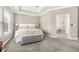 Serene bedroom with tray ceiling, soft carpet, and a view to the ensuite bathroom at 307 S Gomez Ave # 1, Tampa, FL 33609