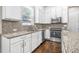 Kitchen with white cabinetry, stainless steel appliances, and granite countertops at 307 S Gomez Ave # 1, Tampa, FL 33609
