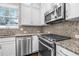 Modern kitchen with stainless steel appliances and stylish mosaic backsplash at 307 S Gomez Ave # 1, Tampa, FL 33609
