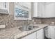 Close-up of the kitchen sink and countertops with stainless steel appliances at 307 S Gomez Ave # 1, Tampa, FL 33609
