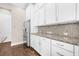 Kitchen with white cabinetry, stainless steel refrigerator, and granite countertops at 307 S Gomez Ave # 1, Tampa, FL 33609