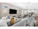 Spacious living room with large sectional sofa, modern lighting, and open view to the kitchen at 307 S Gomez Ave # 1, Tampa, FL 33609