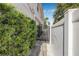 Landscaped side yard with a gated walkway and privacy fence at 307 S Gomez Ave # 1, Tampa, FL 33609