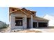 A new construction home featuring concrete block and wood framing, set against a clear blue sky in a residential neighborhood at 31418 Hayman Loop, Wesley Chapel, FL 33545