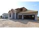 New home construction shows concrete block exterior, wood framing, and garage in a sunny residential development at 31418 Hayman Loop, Wesley Chapel, FL 33545