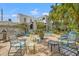 Beautiful backyard featuring a brick patio, lush landscaping, and charming home exterior with black and white awning at 356 22Nd Ne Ave, St Petersburg, FL 33704