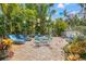 Charming backyard featuring a brick patio, outdoor dining area, grill and lush tropical landscaping, perfect for relaxation at 356 22Nd Ne Ave, St Petersburg, FL 33704