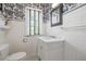 Bathroom featuring subway tile, bold wallpaper, and a sleek vanity with a marble countertop at 356 22Nd Ne Ave, St Petersburg, FL 33704