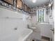 Charming bathroom featuring a classic clawfoot tub and decorative black and white wallpaper at 356 22Nd Ne Ave, St Petersburg, FL 33704