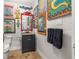 Unique powder room features vibrant art, colorful mirror and fixtures, and unique decor at 356 22Nd Ne Ave, St Petersburg, FL 33704