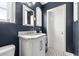 Modern bathroom featuring a vanity with marble countertop, a unique mirror, and patterned tile flooring at 356 22Nd Ne Ave, St Petersburg, FL 33704