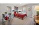 Cozy bedroom with a plush red bed, modern decor, and plenty of natural light at 356 22Nd Ne Ave, St Petersburg, FL 33704