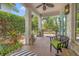 Charming covered porch with outdoor seating, a ceiling fan, and lush greenery at 356 22Nd Ne Ave, St Petersburg, FL 33704