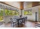 Enclosed patio with a dining table set for six, offering a serene outdoor dining experience at 356 22Nd Ne Ave, St Petersburg, FL 33704